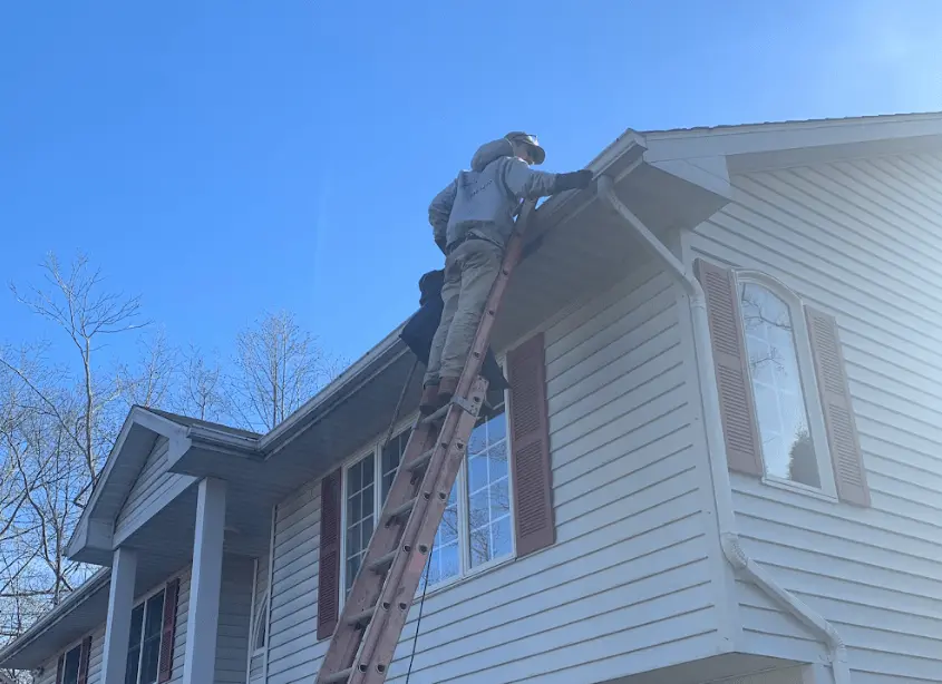 Gutter cleaning and maintenance being performed by Parma Power Washing in Parma